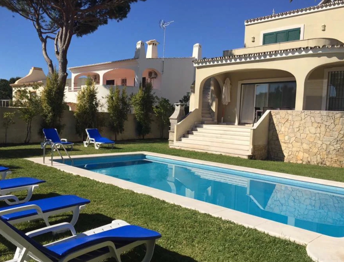 Piscina de villa no Algarve com espreguiçadeiras azuis — requisitos de conformidade de Lagoa para villas em Carvoeiro