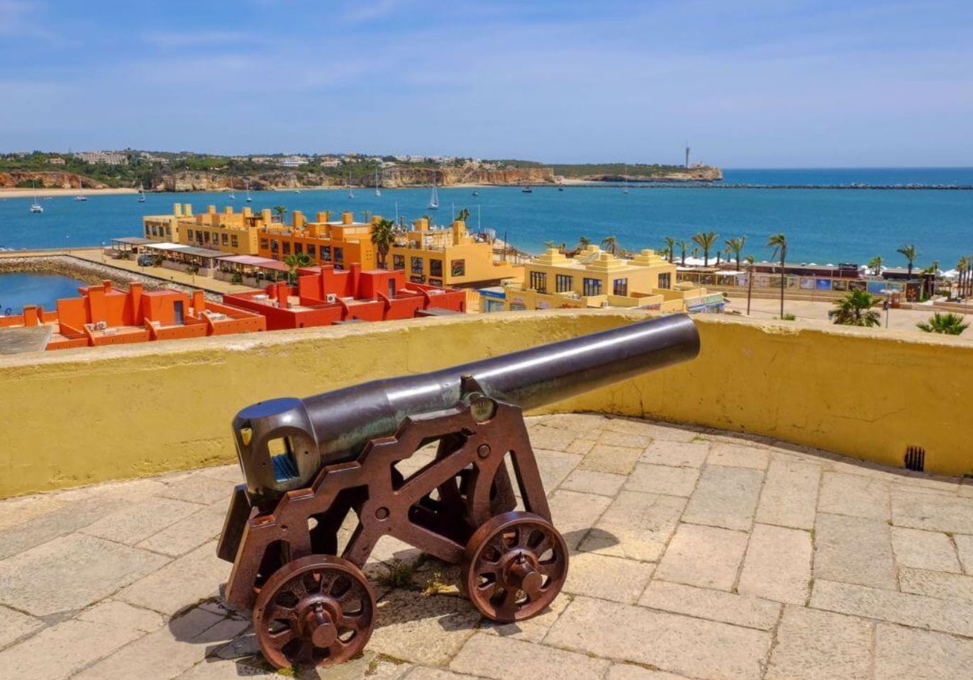 Lagos fort cannon overlooking the colourful marina — AL registration guide for UK villa owners